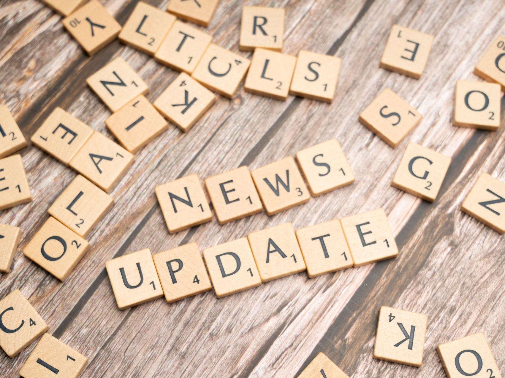 Scrabble Steine, die die Wörter News und Update zeigen